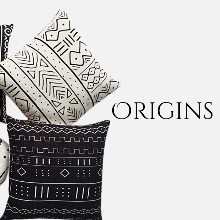 Two decorative throw pillows with bold tribal-inspired geometric patterns in black and white tones, arranged against a clean background with the word "ORIGINS" in a bold, elegant font.