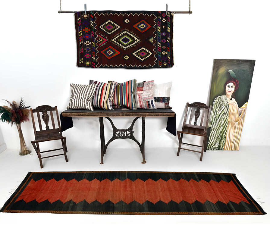 Tribal vintage kilim on the white wall and black-red vintage kilim runner on the floor.