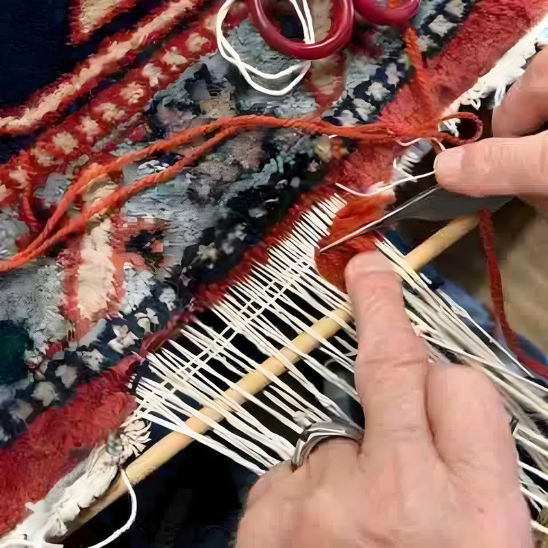 A carpet repair technician working on the edge of a vintage rug, restoring its original shape and design.