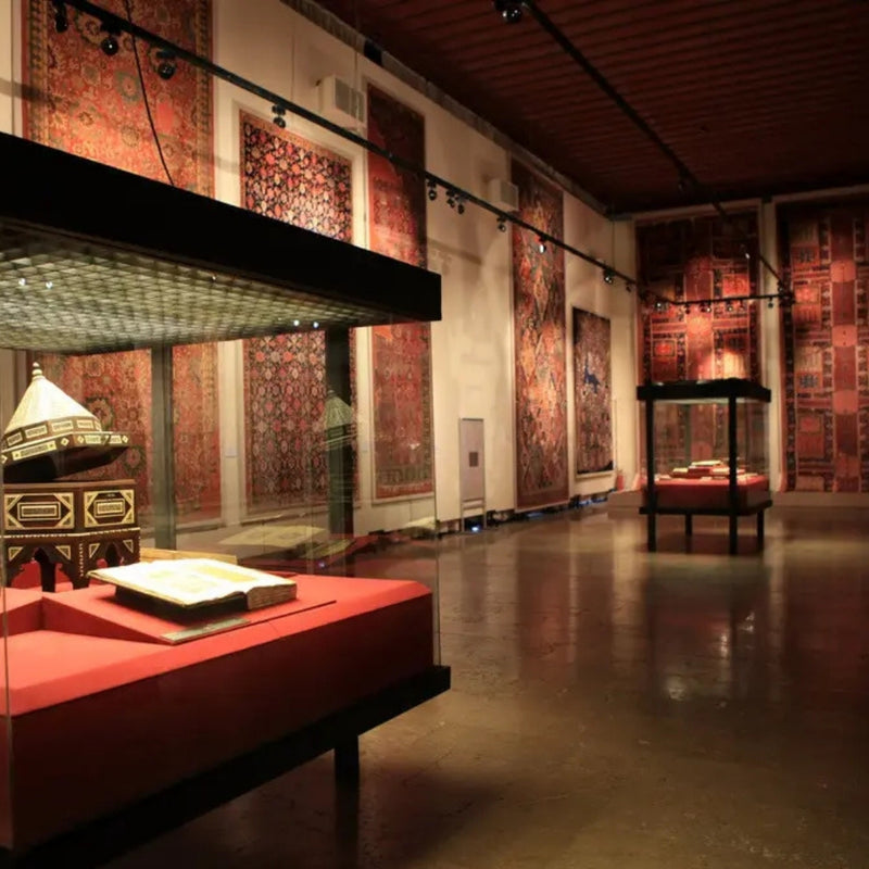 Vintage rugs displayed in a museum, showcasing their intricate designs and historical significance.